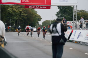 Sammie Stuart of CAMS-Basso crosses the finish line on the end of stage 4 in the rain